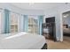 Bright bedroom features a plush bed, dark dresser with a TV, and serene decor at 3401 N Ocean Blvd. # 109, North Myrtle Beach, SC 29582