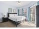 Bedroom with a large bed, natural light and a view of the outside at 3401 N Ocean Blvd. # 109, North Myrtle Beach, SC 29582