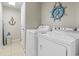 Laundry room features a washer and dryer, and nautical-themed decor at 3401 N Ocean Blvd. # 109, North Myrtle Beach, SC 29582