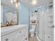 Bathroom boasts a large vanity, framed mirror, stand up shower with glass doors, and white fixtures at 3407 Poinsett St., North Myrtle Beach, SC 29582