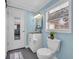 Charming bathroom featuring a vanity sink, toilet, and a window with natural light at 3407 Poinsett St., North Myrtle Beach, SC 29582