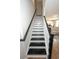 View of the staircase with black treads and white risers at 3491 Alexandria Ave., Myrtle Beach, SC 29577