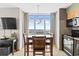 A cozy dining area next to the kitchen with ocean views, featuring a modern light fixture at 3601 N Ocean Blvd. # 1840, North Myrtle Beach, SC 29582