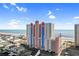 Striking exterior view of the oceanfront condo building with colorful architecture and beach views at 3601 N Ocean Blvd. # 1840, North Myrtle Beach, SC 29582