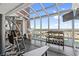Bright gym features large windows with skyline view, modern equipment, and a TV at 3601 N Ocean Blvd. # 1840, North Myrtle Beach, SC 29582