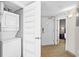 Hallway featuring a stacked washer and dryer and a view into the bedroom at 3601 N Ocean Blvd. # 1840, North Myrtle Beach, SC 29582