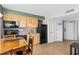 A well-lit kitchen features wooden cabinetry, black appliances, and neutral tiled flooring at 3601 N Ocean Blvd. # 1840, North Myrtle Beach, SC 29582