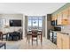 Open-concept living room with large windows providing stunning views and a dining area at 3601 N Ocean Blvd. # 1840, North Myrtle Beach, SC 29582
