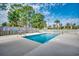 Outdoor swimming pool enclosed by white and wood fences with surrounding trees at 4225 Rivergate Ln., Little River, SC 29566