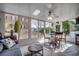 Bright sunroom with multiple windows, a ceiling fan, and comfortable seating for relaxing or entertaining at 4225 Rivergate Ln., Little River, SC 29566