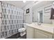 Functional bathroom featuring a shower with a patterned curtain and a neutral vanity at 4506 W Harbour Ct. # U2, Little River, SC 29566