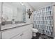 Bright bathroom with a granite vanity top, and a blue patterned shower curtain at 4506 W Harbour Ct. # U2, Little River, SC 29566