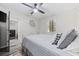 Well-lit bedroom with a ceiling fan, wood-look flooring, and a view into the ensuite bathroom at 4506 W Harbour Ct. # U2, Little River, SC 29566