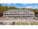 Three-story condo building with a large parking area surrounded by green trees and landscaped grounds at 4506 W Harbour Ct. # U2, Little River, SC 29566