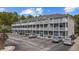 Three-story building with gray siding and white balconies, offering ample parking space for residents at 4506 W Harbour Ct. # U2, Little River, SC 29566