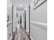 Hallway featuring wood-style floors, doors and trim painted in neutral colors, and modern lighting fixtures at 4506 W Harbour Ct. # U2, Little River, SC 29566