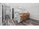 Kitchen snack bar with wood chairs, neutral walls, white cabinets, and wood-style flooring at 4506 W Harbour Ct. # U2, Little River, SC 29566
