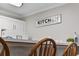 An open kitchen area has a snack bar with white appliances, and the wall has a 'Kitchen' decor piece at 4506 W Harbour Ct. # U2, Little River, SC 29566
