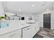 Open kitchen featuring a modern sink, white cabinets, and a pass-through to the living area at 4506 W Harbour Ct. # U2, Little River, SC 29566