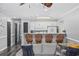 Living room view of a kitchen bar with wood chairs, neutral walls, white cabinets, and a ceiling fan at 4506 W Harbour Ct. # U2, Little River, SC 29566