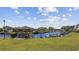Beautiful waterfront view featuring a gazebo, boat dock, and residential buildings at 4506 W Harbour Ct. # U2, Little River, SC 29566