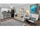 Inviting living room featuring a comfortable leather sofa, stylish decor, and a ceiling fan at 4709 Cobblestone Dr. # F5, Myrtle Beach, SC 29577