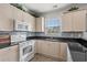 Close-up of the kitchen with stainless appliances, granite countertops, and tile backsplash at 4894 Luster Leaf Circle # 301, Myrtle Beach, SC 29577