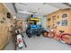 Organized garage featuring a motorcycle, golf cart, bicycles, storage, and various automotive signs on the wall at 516 S 8Th Ave.S, Surfside Beach, SC 29575