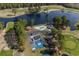 An aerial view shows community amenities, including a pool, tennis courts, and parking at 5215 Southern Trail, Myrtle Beach, SC 29579