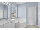 Primary bath boasts double sink, vanity with granite countertop, soaking tub and lots of natural light at 5215 Southern Trail, Myrtle Beach, SC 29579