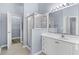 Bathroom with large mirror, large glass shower, and white cabinets at 5215 Southern Trail, Myrtle Beach, SC 29579