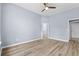 Spacious bedroom features wood floors, a ceiling fan, and ensuite bathroom and hallway at 5215 Southern Trail, Myrtle Beach, SC 29579