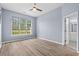 Spacious bedroom featuring hardwood floors, a ceiling fan, and a large window that provides an abundance of natural light at 5215 Southern Trail, Myrtle Beach, SC 29579