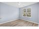 This bedroom features hardwood floors, a ceiling fan, and lots of natural light at 5215 Southern Trail, Myrtle Beach, SC 29579