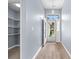 Bright entryway featuring wood floors, a modern light fixture, and a convenient storage closet to the left at 5215 Southern Trail, Myrtle Beach, SC 29579