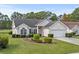 Charming one-story home featuring a well-manicured lawn, mature trees, and an attached two-car garage at 5215 Southern Trail, Myrtle Beach, SC 29579