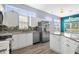 Bright kitchen features white cabinets, stainless steel appliances, granite countertops, and a mosaic backsplash at 5215 Southern Trail, Myrtle Beach, SC 29579