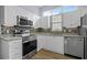 Kitchen with stainless appliances, granite countertops, undermount lighting and gray backsplash at 5215 Southern Trail, Myrtle Beach, SC 29579