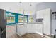 Open-concept kitchen boasts granite counters, white cabinets, stainless steel appliances, with view to the living area at 5215 Southern Trail, Myrtle Beach, SC 29579