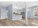 Open concept showcasing modern kitchen and breakfast bar with a stylish pillar offering separation from the living space at 5215 Southern Trail, Myrtle Beach, SC 29579
