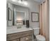 Well-lit bathroom showcasing a vanity, a large mirror, and a decorative shower curtain at 2505 Brescia St., Myrtle Beach, SC 29579