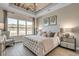 Elegant bedroom featuring a tufted headboard, chandelier, and stunning lake view at 52505 Brescia St., Myrtle Beach, SC 29579