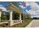 Bella Vita community entrance with manicured landscaping, impressive signage, and an American flag at 52505 Brescia St., Myrtle Beach, SC 29579