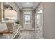 Welcoming entryway with wood floors, console table, decorative lamp, and transom window above the front door at 2505 Brescia St., Myrtle Beach, SC 29579