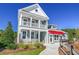 Charming two-story home with a double porch, manicured landscaping, and a bright red awning at 2505 Brescia St., Myrtle Beach, SC 29579