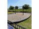 Community swing set in a grassy area with mature trees and a border fence at 2505 Brescia St., Myrtle Beach, SC 29579