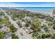 An aerial view shows a property near a road and a beach with high-rise buildings visible in the background at 5520 N Kings Hwy., Myrtle Beach, SC 29577