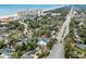 Aerial view of a home nestled among trees near the beach, with a highway nearby and city skyline on the horizon at 5520 N Kings Hwy., Myrtle Beach, SC 29577