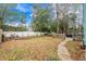 Spacious backyard with a white fence, small garden area, and stone path at 5520 N Kings Hwy., Myrtle Beach, SC 29577