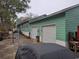 View of the home's exterior, highlighting the attached garage and the driveway next to the yard at 5520 N Kings Hwy., Myrtle Beach, SC 29577